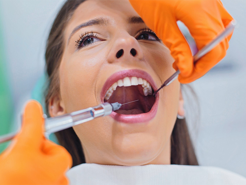 Dentist giving anesthesia to the patient